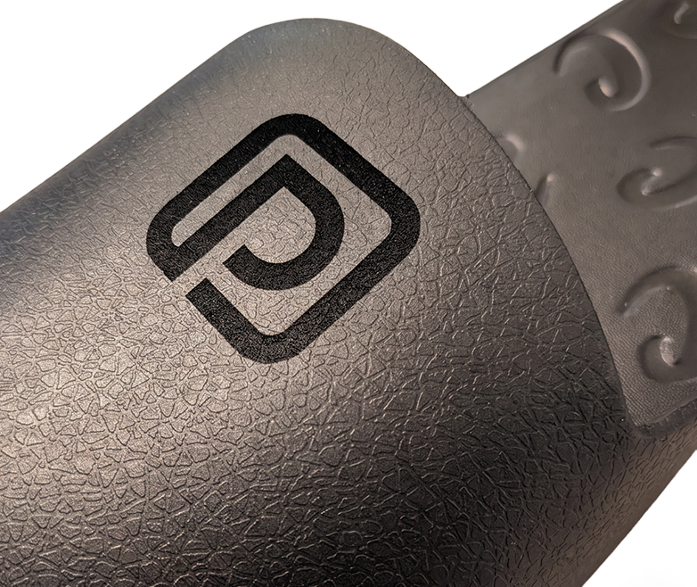 Monogram logo laser engraved on a black Creams toe cap