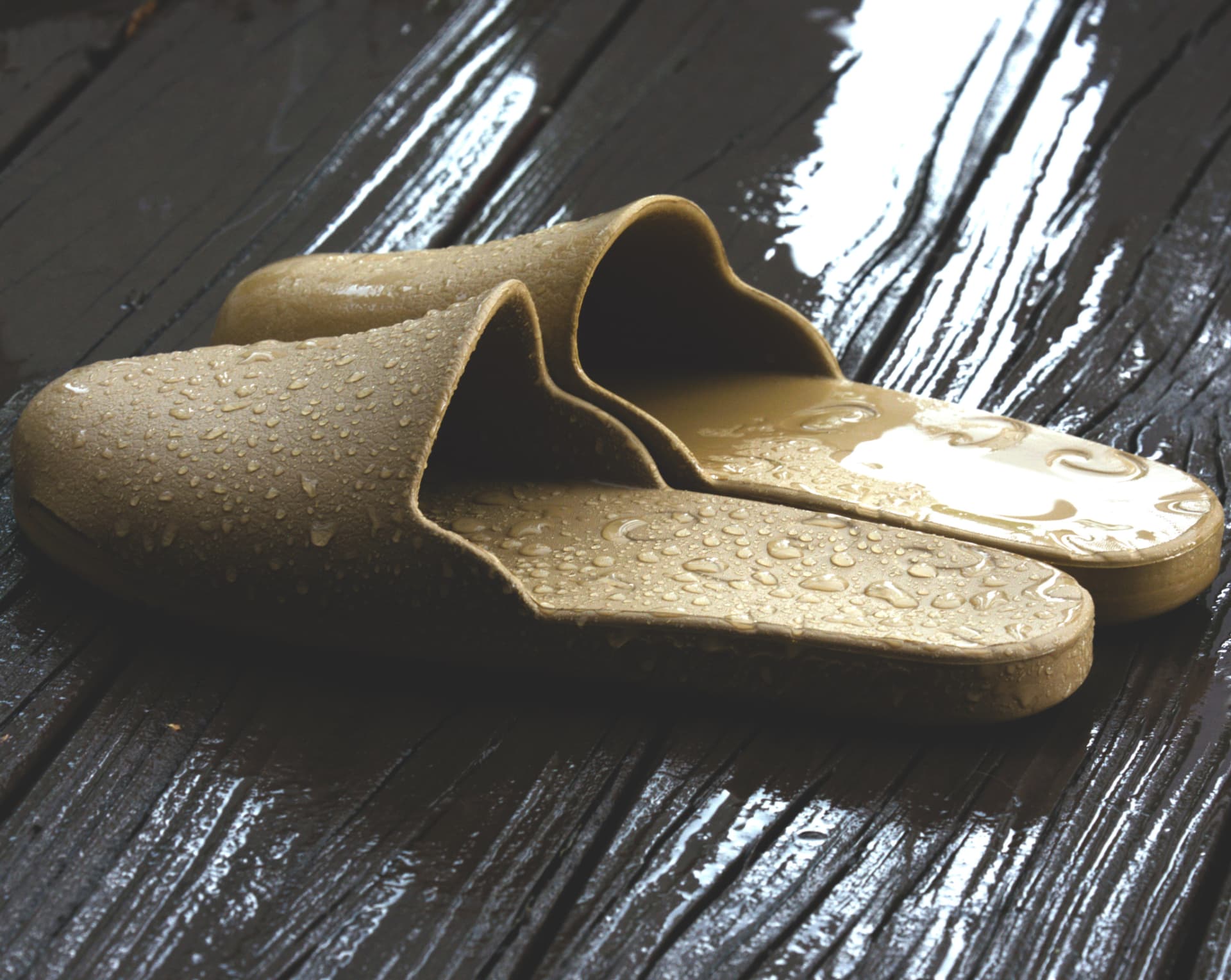 Tan Creams slides beaded with water on wet decking