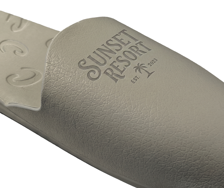 Sunset Resort logo laser engraved on a sage Creams toe cap
